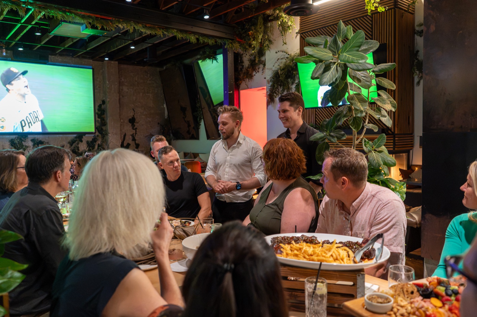 Guests greeting each other around the table
