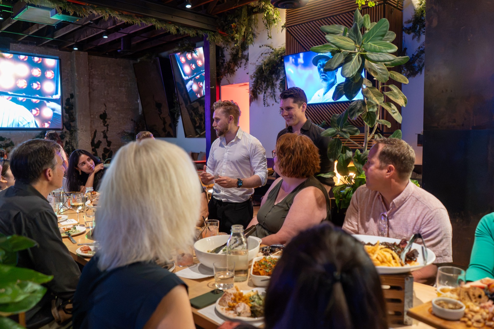 Guests at the table with the host standing between them