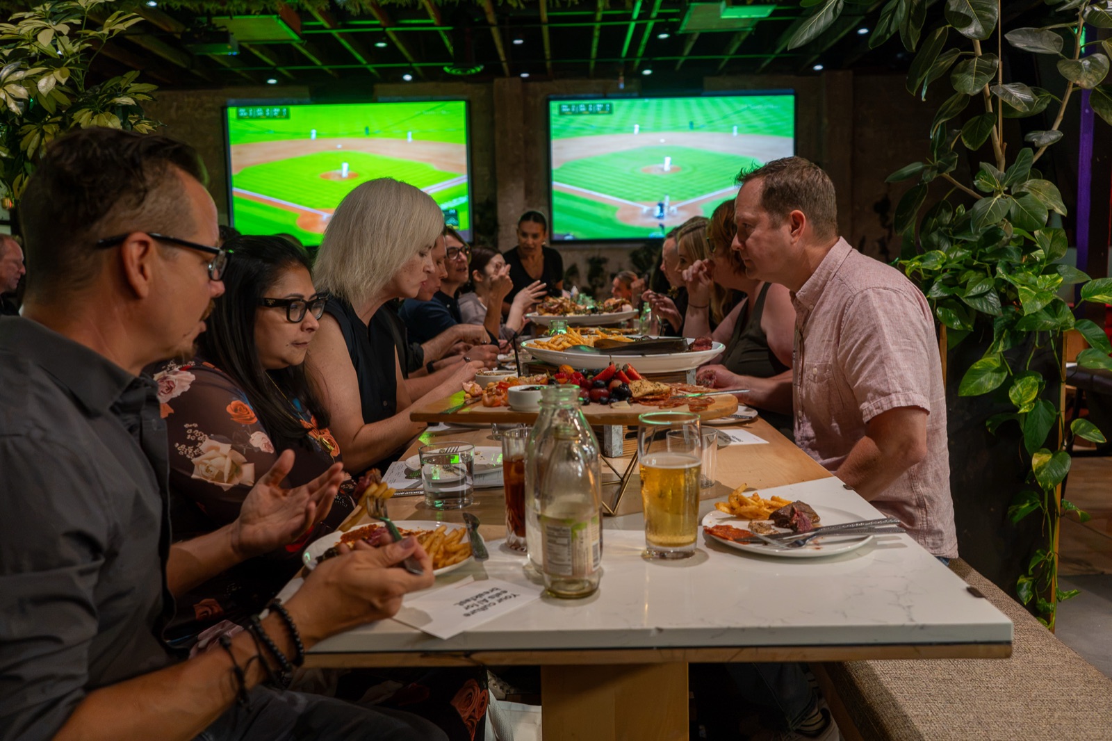 The full table seen from one end, every seat taken